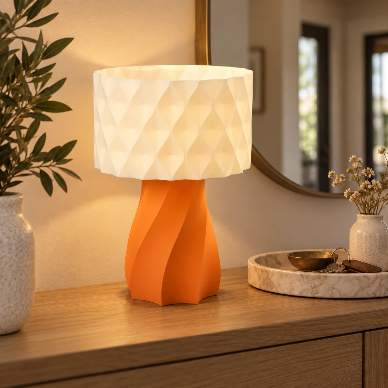 Pink Bnana Twirl Glow Table Lamp with orange base glowing on a console table