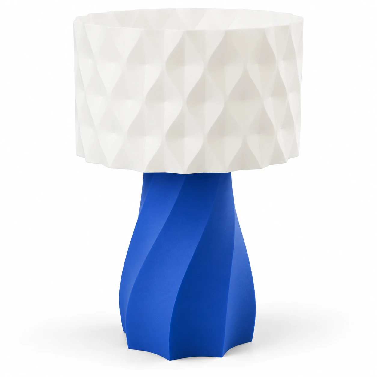 Pink Bnana Twirl Glow Table Lamp with royal blue twisted base and white geometric shade on a white background